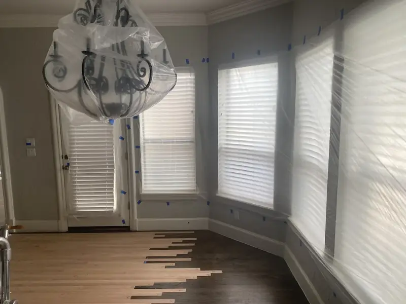 New hardwood boards woven into an existing floor during a repair